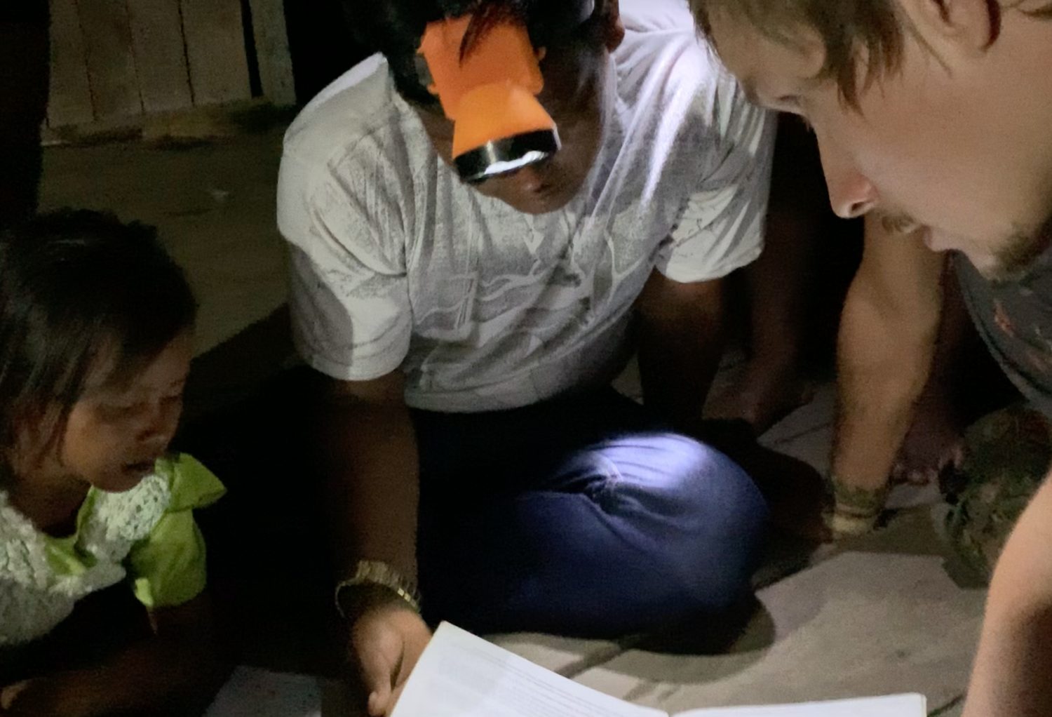 By candlelight at Maraã — the village accounts in a school notebook.